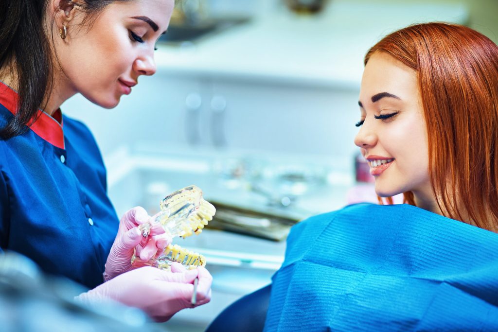 Dentista explicando tratamento com modelo de dentes na Sorridents Porto Alegre